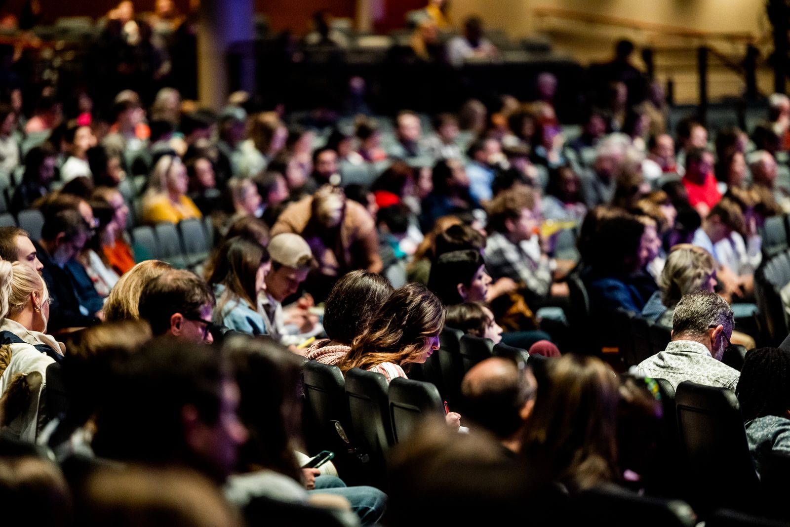 A large audience seated in rows at a conference