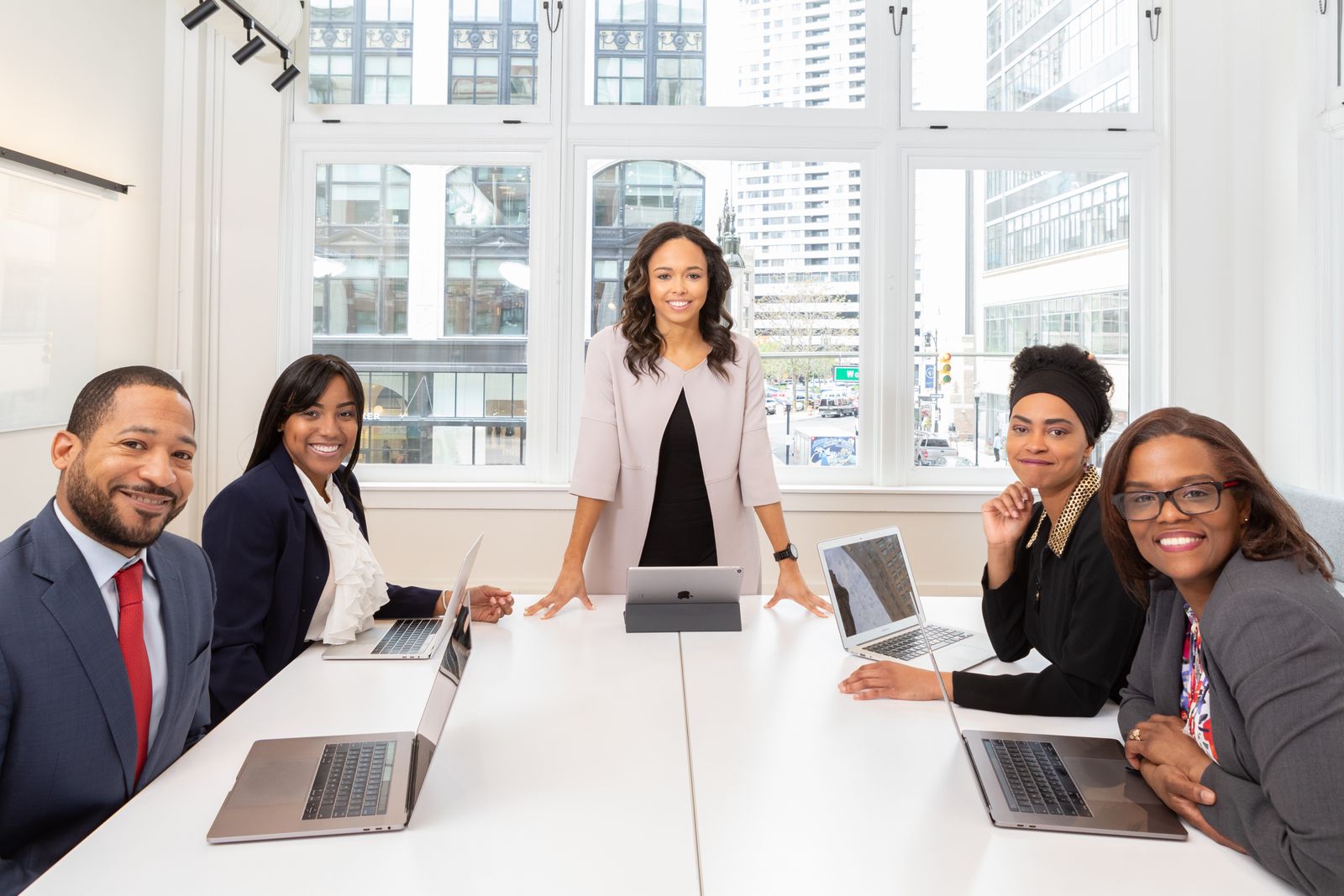 A team gathered around a table with laptops open