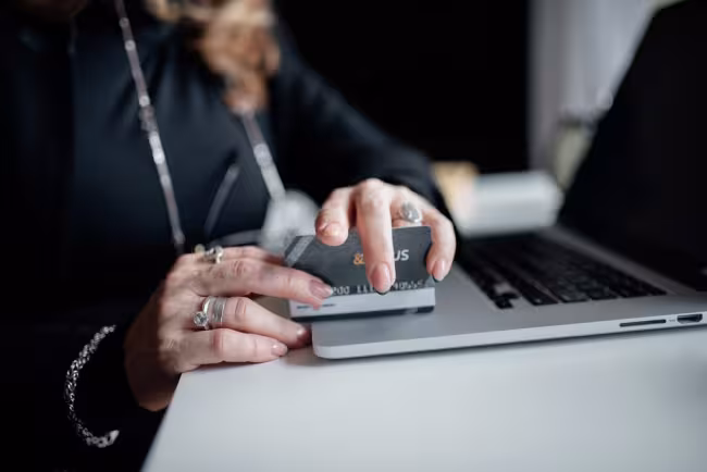 A person entering payment card details on a laptop