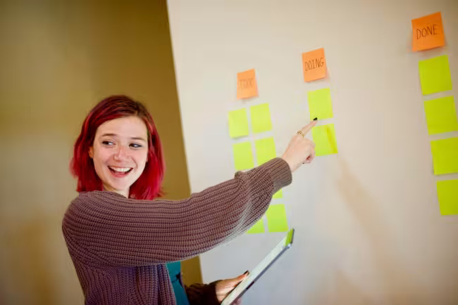 A scrum board covered in coloured sticky notes for sprint planning